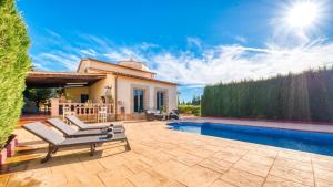 a backyard with a pool and a house at Costacabana - Villa Roxy in Lloret de Mar