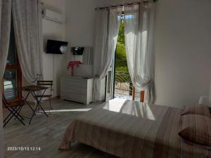 a bedroom with a bed and a large window at Casaiole2023 in Taranto