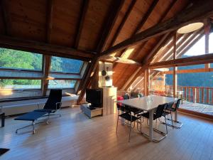 a dining room with a table and chairs in a house at The Loft 3 minutes from Alpe dHuez Grand Domaine via Oz en Oisans in Oz