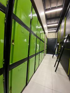a hallway of green lockers in a building at Hotel Joy Cll 85 in Bogotá