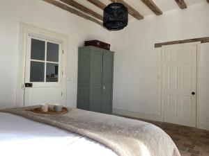 a bedroom with a bed with a green cabinet at Domaine la Boulinière - La Biche in Journet +16 photos