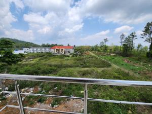 a house on top of a grassy hill at Coffee valley resort (CVR) in Yercaud