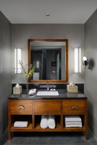 a bathroom with a sink and a mirror at Taj Guras Kutir Resort & Spa, Gangtok in Gangtok