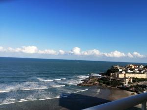 a view of the ocean from a balcony at Apartamento, ampla sacada com vista para o mar! in Itanhaém