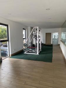 a room with a gym with a treadmill at Luxurious 2 Bedroom space Available in Accra