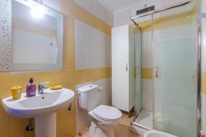 ein Badezimmer mit Toilette, Waschbecken und Dusche in der Unterkunft Flatguest Namibia SIN ASCENSOR in Mogán