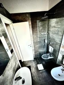 a bathroom with a toilet and a sink at Dazio Exclusive Rooms in Rome