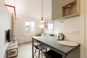 a kitchen with a table and chairs in a room at Bcn Town Apartments Born in Barcelona