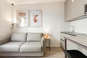 a living room with a couch in a kitchen at Bcn Town Apartments Born in Barcelona