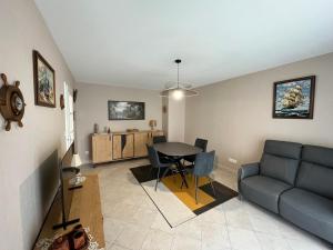 uma sala de estar com uma mesa e um sofá em Appartement Les Sables-d'Olonne, 2 pièces, 2 personnes - FR-1-197-583 em Les Sables-dʼOlonne