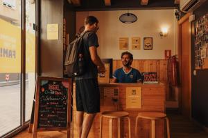 two men standing at a counter in a restaurant at Onefam Sants in Barcelona