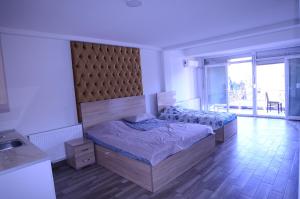 a bedroom with a large bed and a large window at Hotel New York Struga in Struga