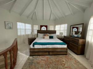 a bedroom with a bed in a room with windows at Unwind at Idyllic Escape! in Dickenson Bay
