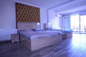 a bedroom with a large bed with a large headboard at Hotel New York Struga in Struga