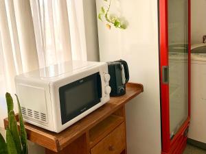 a microwave sitting on top of a wooden table at B&B Mina Clavero in Mina Clavero