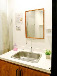 a sink in a bathroom with a mirror above it at Santuario Getsemani Hostel in Cartagena de Indias