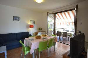 a living room with a table and a blue couch at Residenza Corte Casara in Lazise