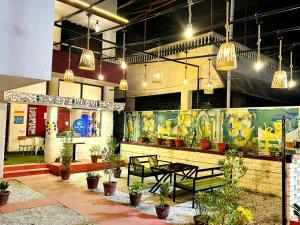 a restaurant with a table and chairs and potted plants at Blue town Hostel & Cafe in Jodhpur