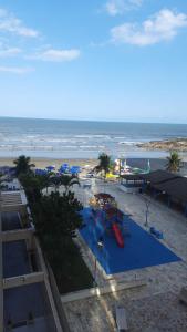 a view of a beach with a playground and the ocean at Apartamento, ampla sacada com vista para o mar! in Itanhaém