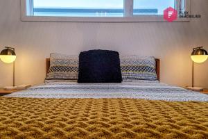 a bedroom with a bed with two lamps and a window at Le Blanc Bouleau de Portneuf / Private Hot tub in Pont-Rouge +54 photos