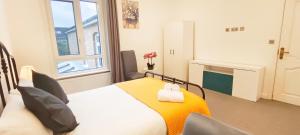 a small bedroom with a bed and a fireplace at Spacious Villa with Garden & Parking 6 Mins to Station in Harrow