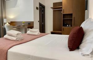 Postel nebo postele na pokoji v ubytování Maison Hotel