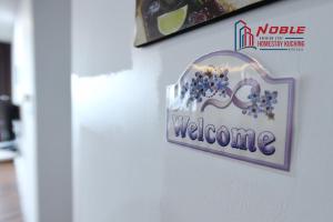 a sign on a wall that says welcome at Noble Vivacity Jazz 2 Cozy Homestay in Kuching