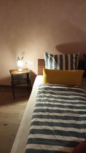 a bedroom with a bed and a table with a lamp at Musik und Theater Gasthof Rössle - Rooms for Angels in Burladingen +16 photos