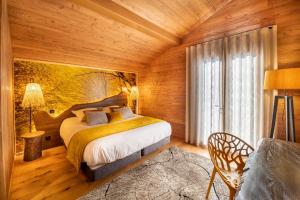 a bedroom with a bed in a wooden room at Chalet Jardin Alpin Valberg in Péone