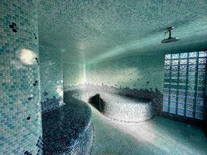 a bathroom with a bath tub and a window at Vista Grande Resort - A Gay Men's Resort in Palm Springs