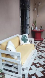 a white couch sitting on a floor in a room at Ribeirinhos Hostel in Maués