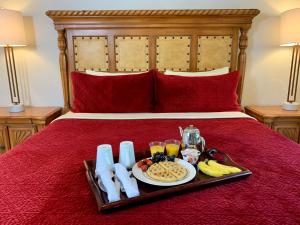 a tray of breakfast food on a bed at Vista Grande Resort - A Gay Men's Resort in Palm Springs