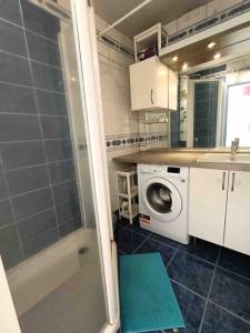 Appartement 6 invités à 25 min du centre de Paris في كاشان: حمام مع دش وغسالة ملابس
