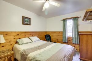 a bedroom with a bed and a ceiling fan at Lakefront Bemidji Getaway with Community Beach! in Bemidji