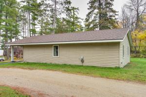 a small white house with a road in front of it at Lakefront Bemidji Getaway with Community Beach! in Bemidji