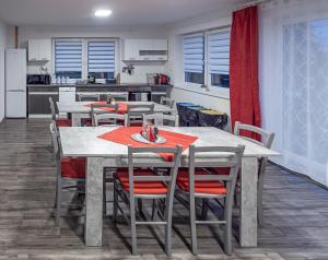 a kitchen and dining room with a table and chairs at Domeček Janov in Janov