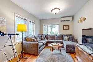 a living room with a couch and a tv at Cliff Retreat in Rockaway Beach