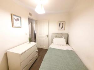 a small bedroom with a bed and a dresser at Accommodation in Stevenage 2 bedrooms in Stevenage