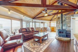 a living room with a couch and a fireplace at Devil's Lookout in Seven Devils