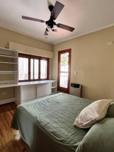 a bedroom with a bed with a ceiling fan at Casita AE 144 - Gualeguaychú, en dólares in Gualeguaychú