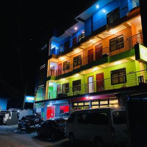 a building with cars parked in front of it at night at Sukhavati Inn in Baguio