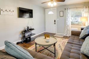 a living room with a couch and a table at Savannah Home with Yard about 3 Mi to Downtown! in Savannah