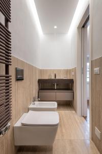 a bathroom with a white toilet and a sink at UNYCA - Duomo Luxury View Florence in Florence +17 photos