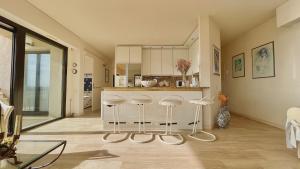 a kitchen with a counter and stools in a room at Luxurious two-bedroom in Cannes