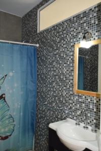 a bathroom with a sink and a mirror at Condo Costa Azul in Costa Azul