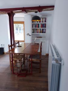 a dining room with a table and chairs and a radiator at Atalaya in Mundaka