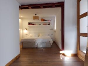 a bedroom with a white bed in a room at Atalaya in Mundaka