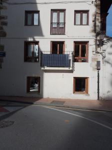a white building with windows and a balcony at Atalaya in Mundaka