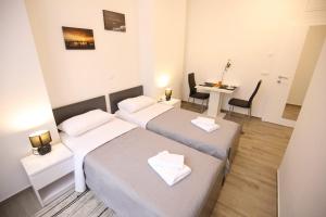 Ein Bett oder Betten in einem Zimmer der Unterkunft Sites Of Zadar Rooms