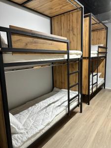 two bunk beds in a room with wooden floors at Hostel O2 in Almaty +42 photos